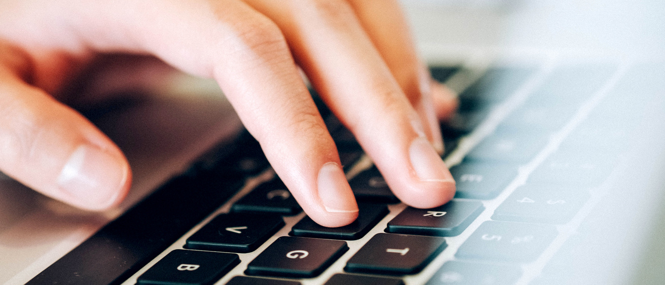 Closeup of computer keyboard with hand typing